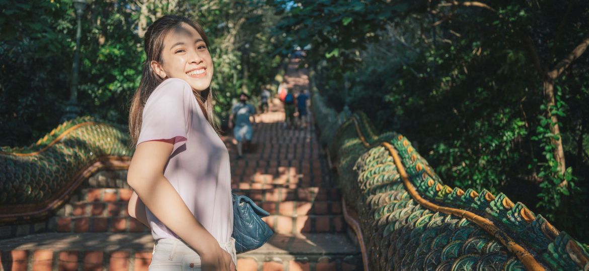 Modern Young adult women thai tourist praying emeral buddha statue at golden stupa Wat Phrathat Doi Suthep ancient temple the most famaus at chiang mai thailand