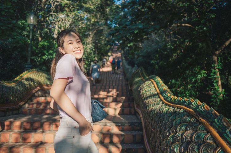 Modern Young adult women thai tourist praying emeral buddha statue at golden stupa Wat Phrathat Doi Suthep ancient temple the most famaus at chiang mai thailand