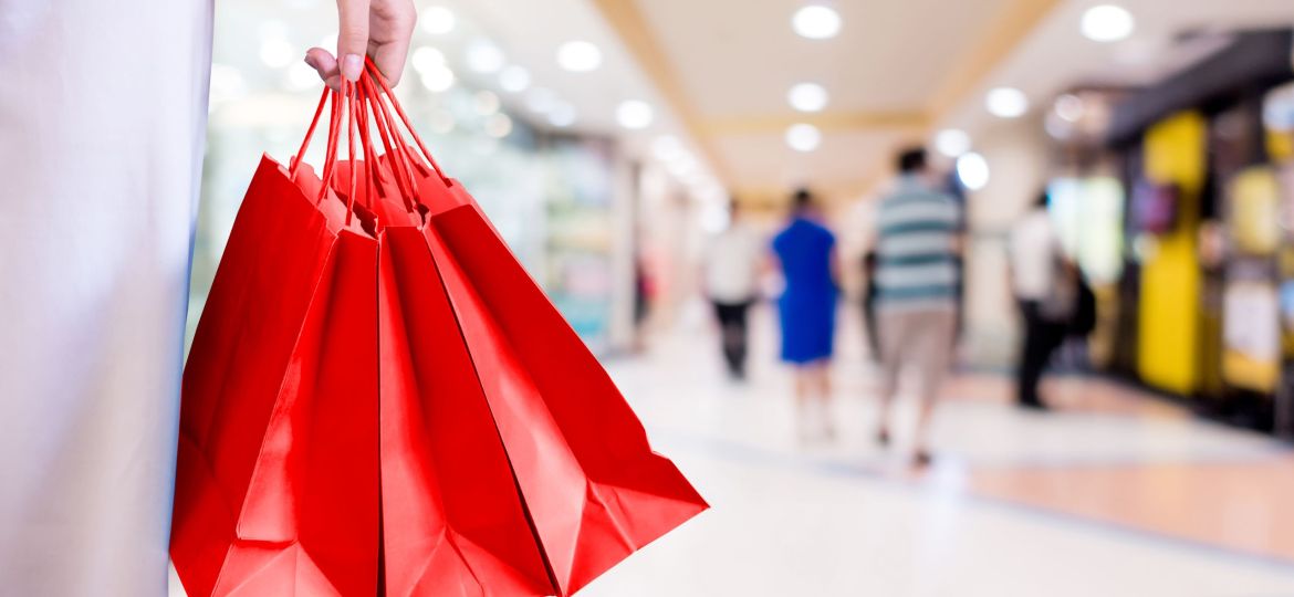 Midsection Of Woman Holding Red Shopping Bags At Mall